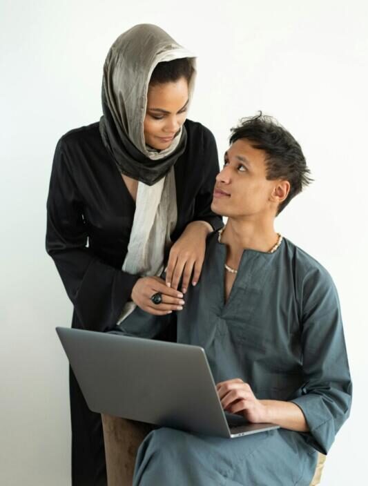 Mother and son studying on the computer.